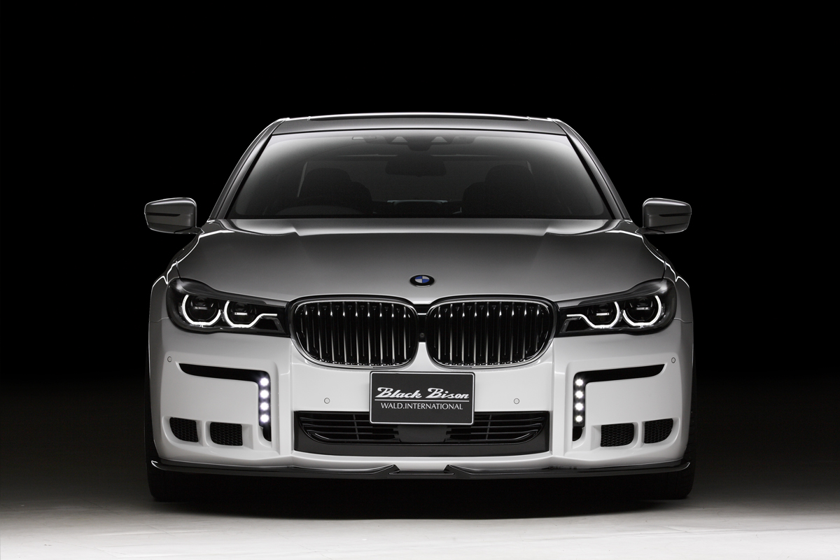 WALD BMW body kit — white BMW 7 Series Black Bison with WALD front bumper, LED daytime running lights and lower lip spoiler